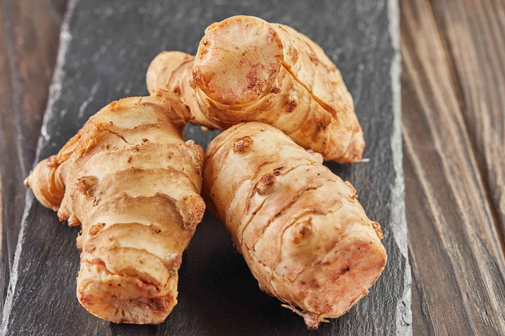 fresh ginger on black stone on wooden background 2026 01 08 07 27 03 utc (1)