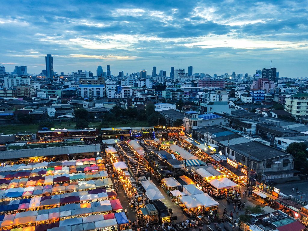 Aerial Shot Market Tents Near Buildings Blue Sky 1024x768